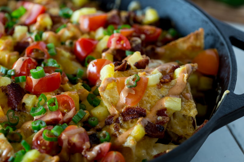 These Pineapple Bacon Nachos with BBQ Salsa will blow your mind. Whip out a batch of these as a game changing snack for your next football party. They are insanely delicious on all the levels.